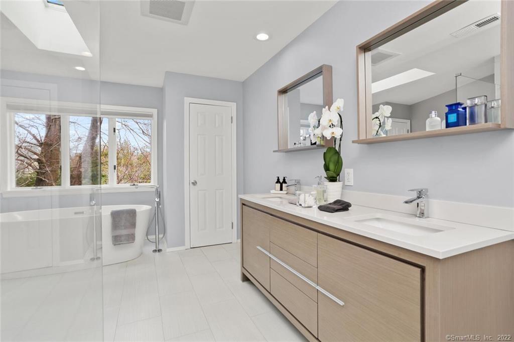 13 Old Stamford Road, Unit 13 New Canaan, CT 06840 - Photo 22 of 39 a bathroom with a double vanity sink window and mirror
