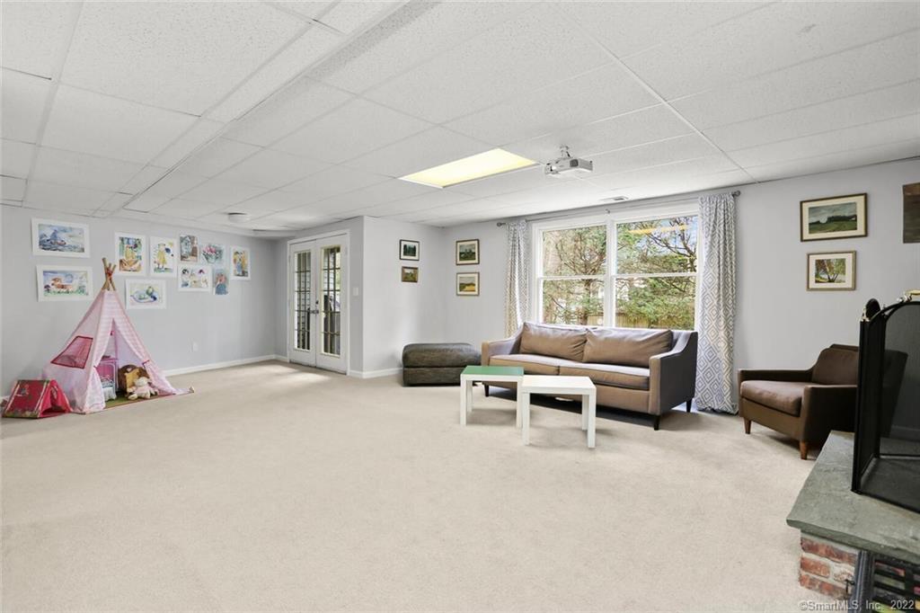 13 Old Stamford Road, Unit 13 New Canaan, CT 06840 - Photo 26 of 39 a living room with furniture and a large window