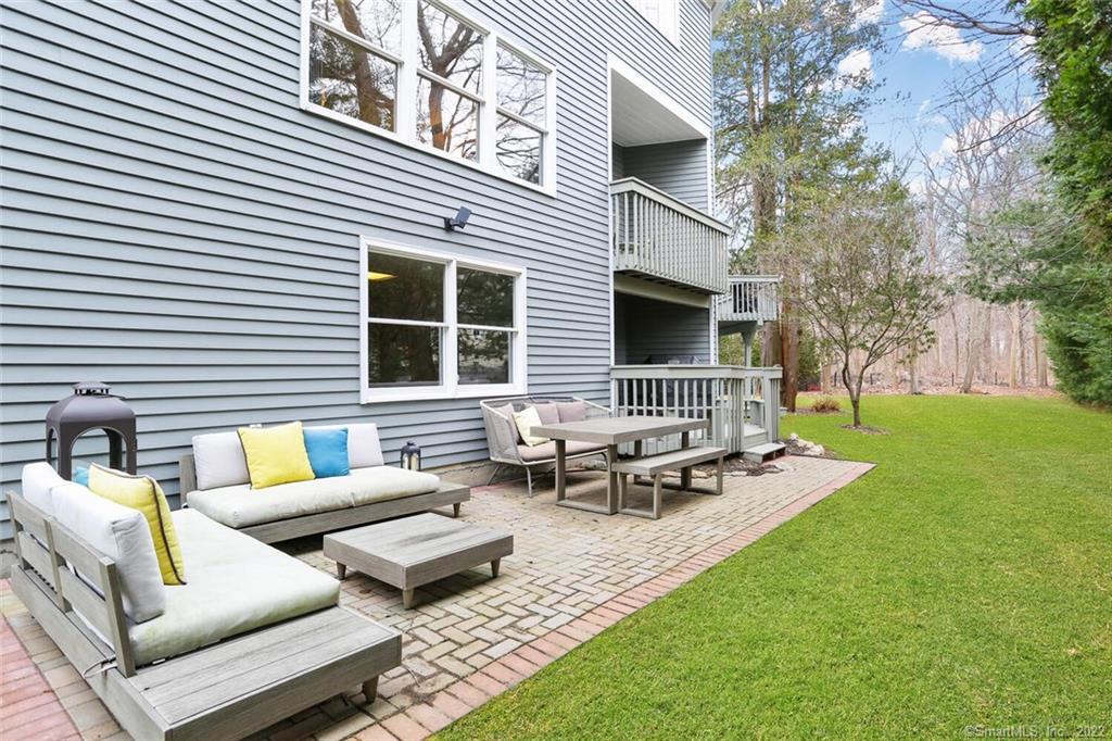 13 Old Stamford Road, Unit 13 New Canaan, CT 06840 - Photo 28 of 39 a view of a patio with couches chairs and a fire pit
