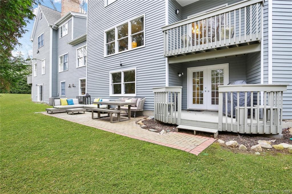 13 Old Stamford Road, Unit 13 New Canaan, CT 06840 - Photo 29 of 39 a view of a house with backyard porch and sitting area