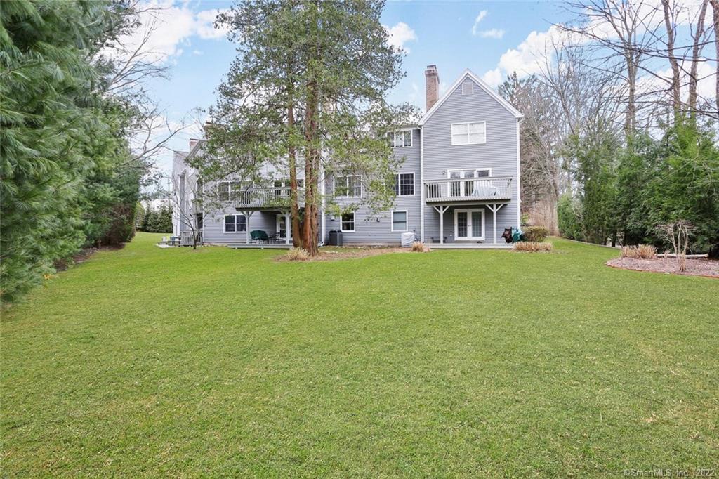 13 Old Stamford Road, Unit 13 New Canaan, CT 06840 - Photo 30 of 39 a view of a house with a big yard and large trees
