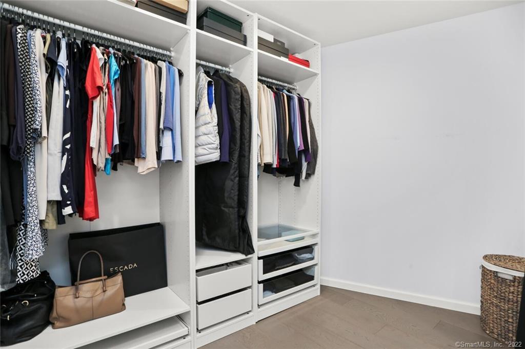 13 Old Stamford Road, Unit 13 New Canaan, CT 06840 - Photo 33 of 39 a view of walk in closet with clothes and shoes