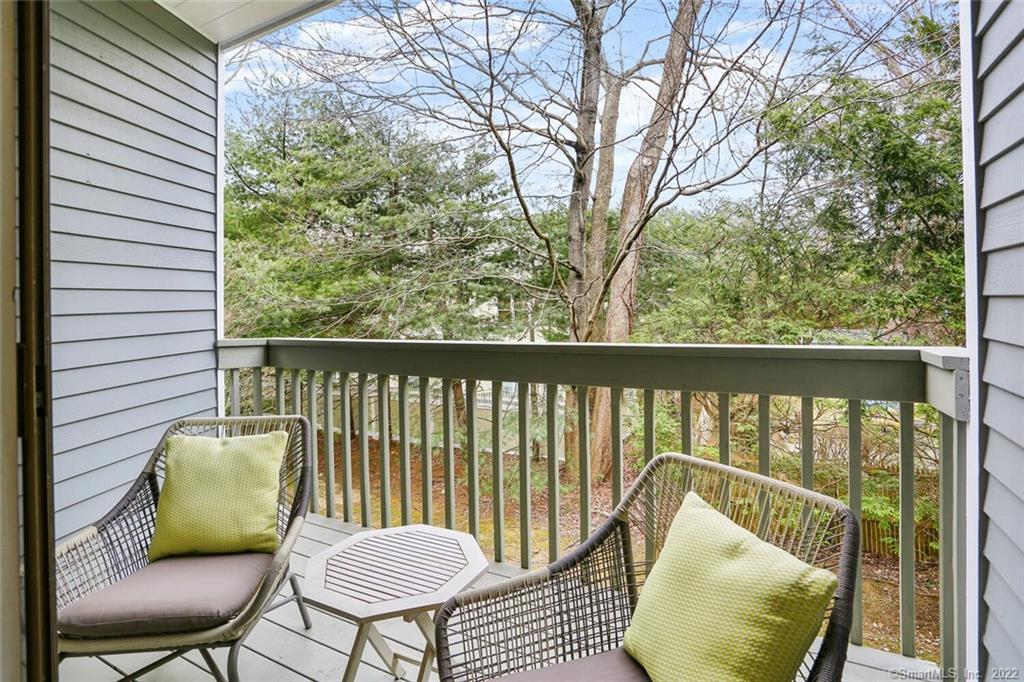 13 Old Stamford Road, Unit 13 New Canaan, CT 06840 - Photo 7 of 39 a view of a chair and table in the balcony
