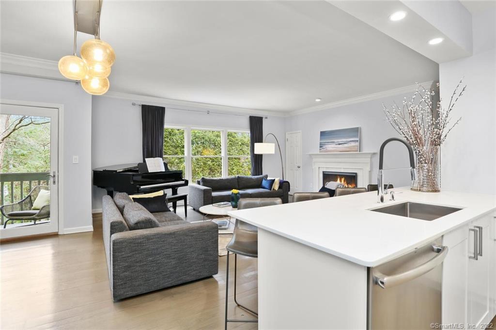 13 Old Stamford Road, Unit 13 New Canaan, CT 06840 - Photo 8 of 39 a living room with fireplace furniture and a large window