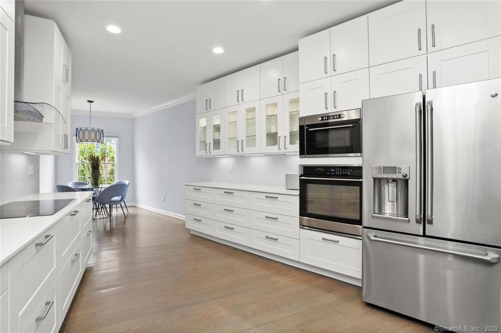 13 Old Stamford Road, Unit 13 New Canaan, CT 06840 - Photo 9 of 39 a kitchen with granite countertop a refrigerator stove and microwave