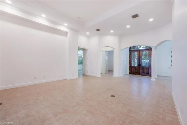 an empty room with closet and windows