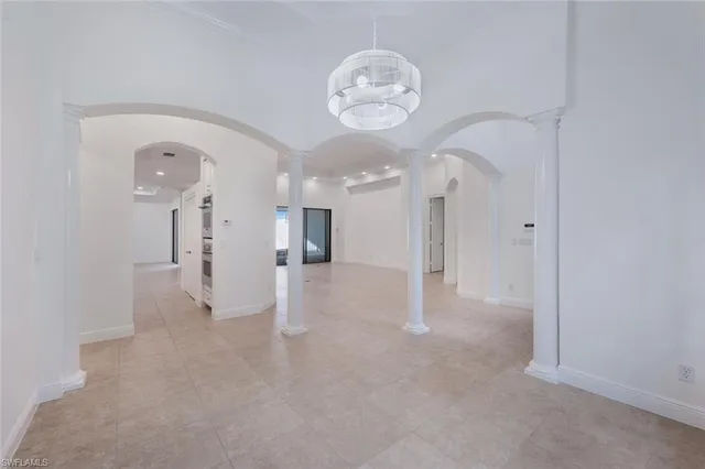 a view of a big room with chandelier fan and windows