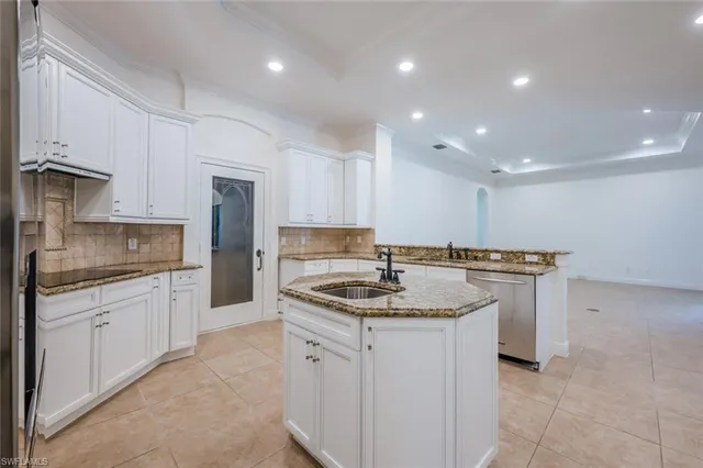 a kitchen with a sink stove cabinets and refrigerator