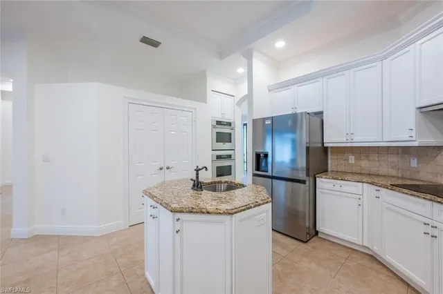 a kitchen with stainless steel appliances granite countertop a sink and cabinets