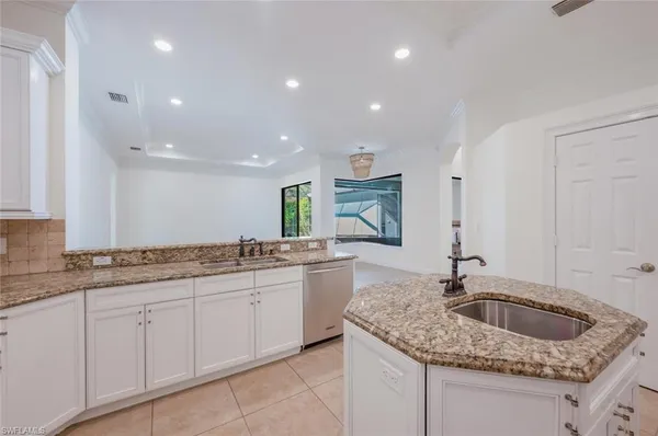 a kitchen with a sink stove and cabinets