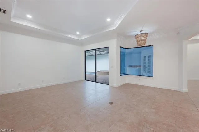 an empty room with closet and windows