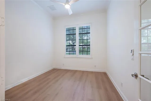 wooden floor in an empty room with a window