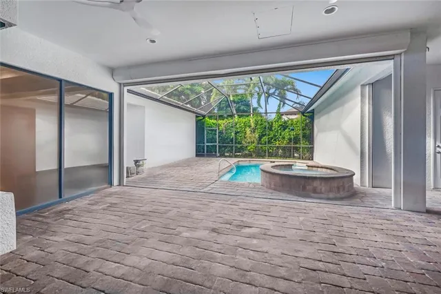 a view of a room with furniture and large windows