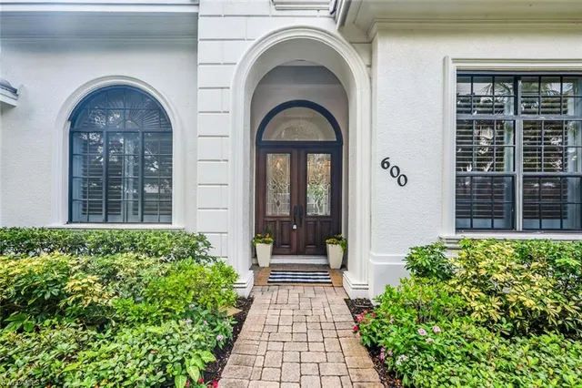 a view of a brick house with large windows