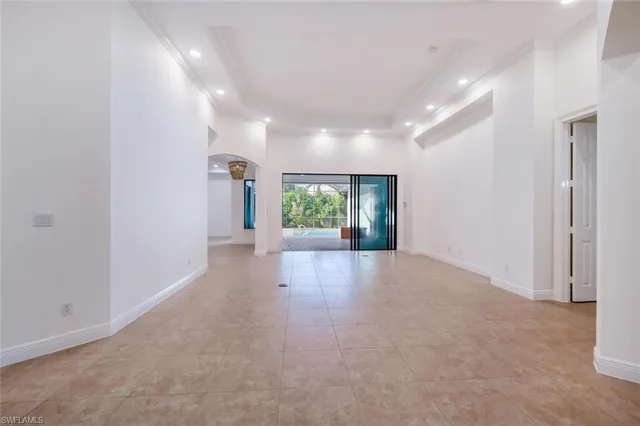 a view of a hallway with an empty room and a window