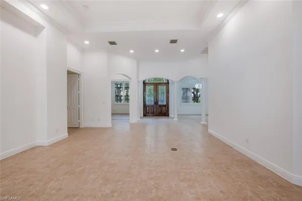 an empty room with closet and mirrors