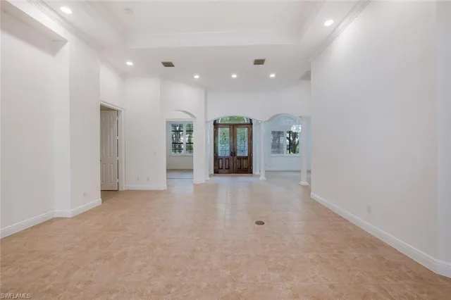 an empty room with closet and mirrors