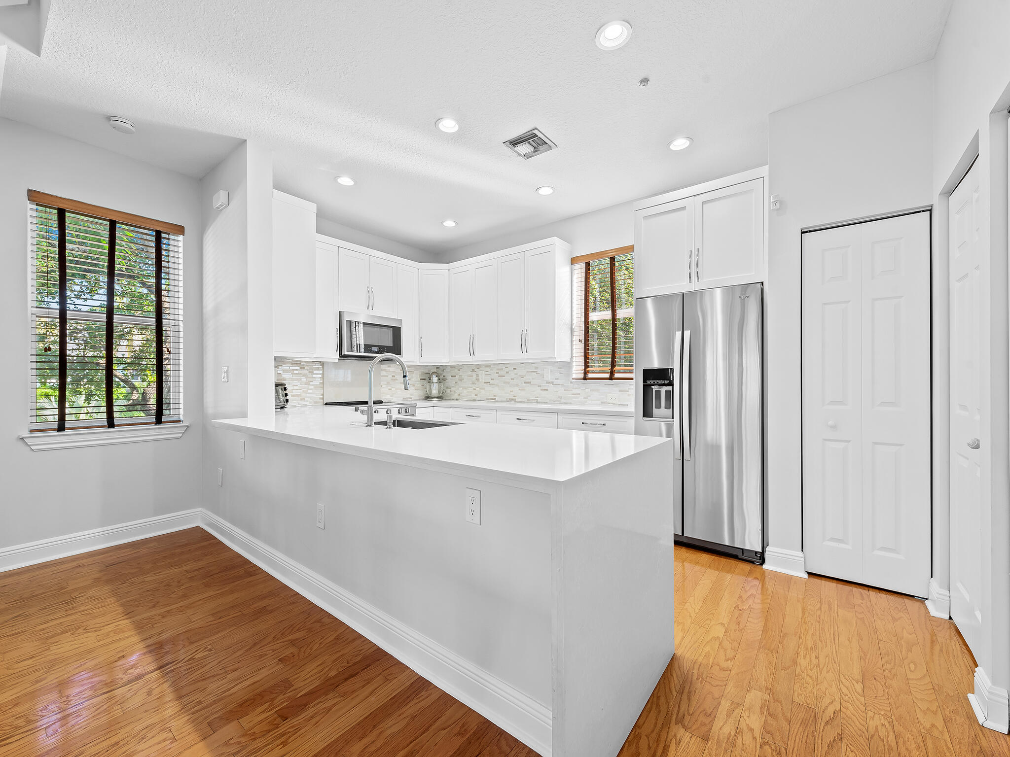 705 Southwest 4th Avenue Fort Lauderdale, FL 33315 - Photo 6 of 25 a large kitchen with kitchen island a sink a center island stainless steel appliances and a window