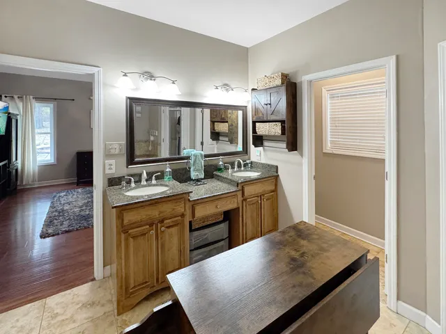 a kitchen with sink cabinets and wooden floor
