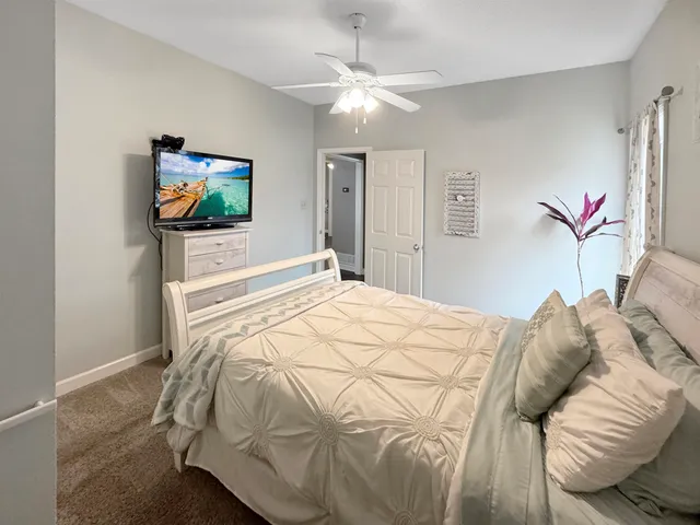 a bedroom with a bed and a tv