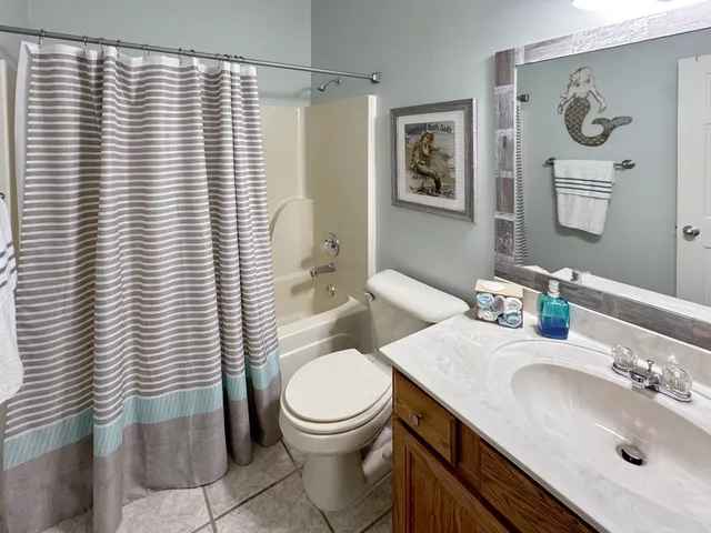 a bathroom with a toilet sink vanity and mirror