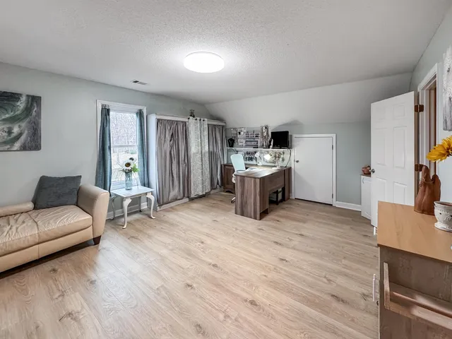 a living room with furniture and a kitchen