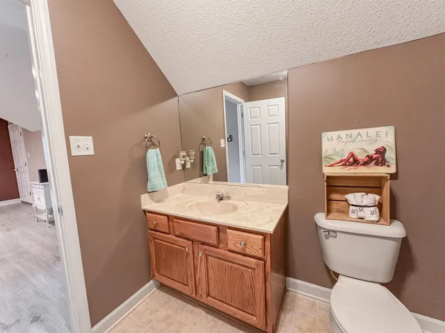 a bathroom with a toilet a sink and a mirror