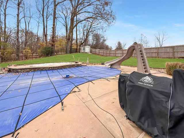 a view of backyard with slide and a bench