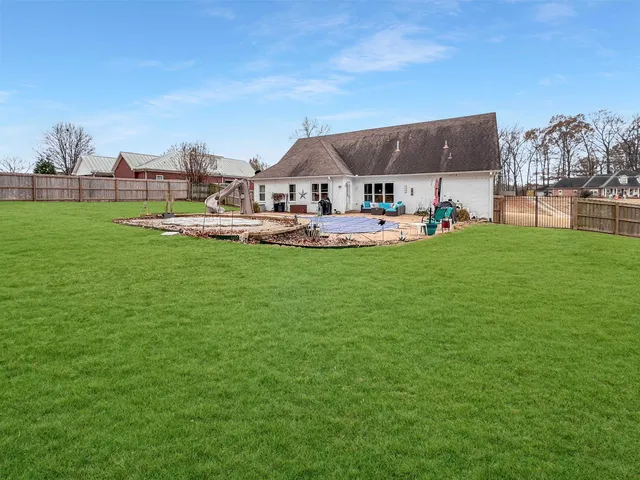a view of a house with garden yard and sitting area