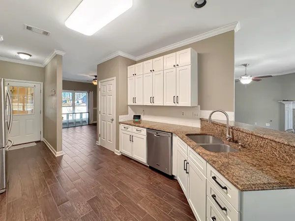 a view of empty room with wooden floor and window