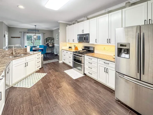 a kitchen with white cabinets and white appliances