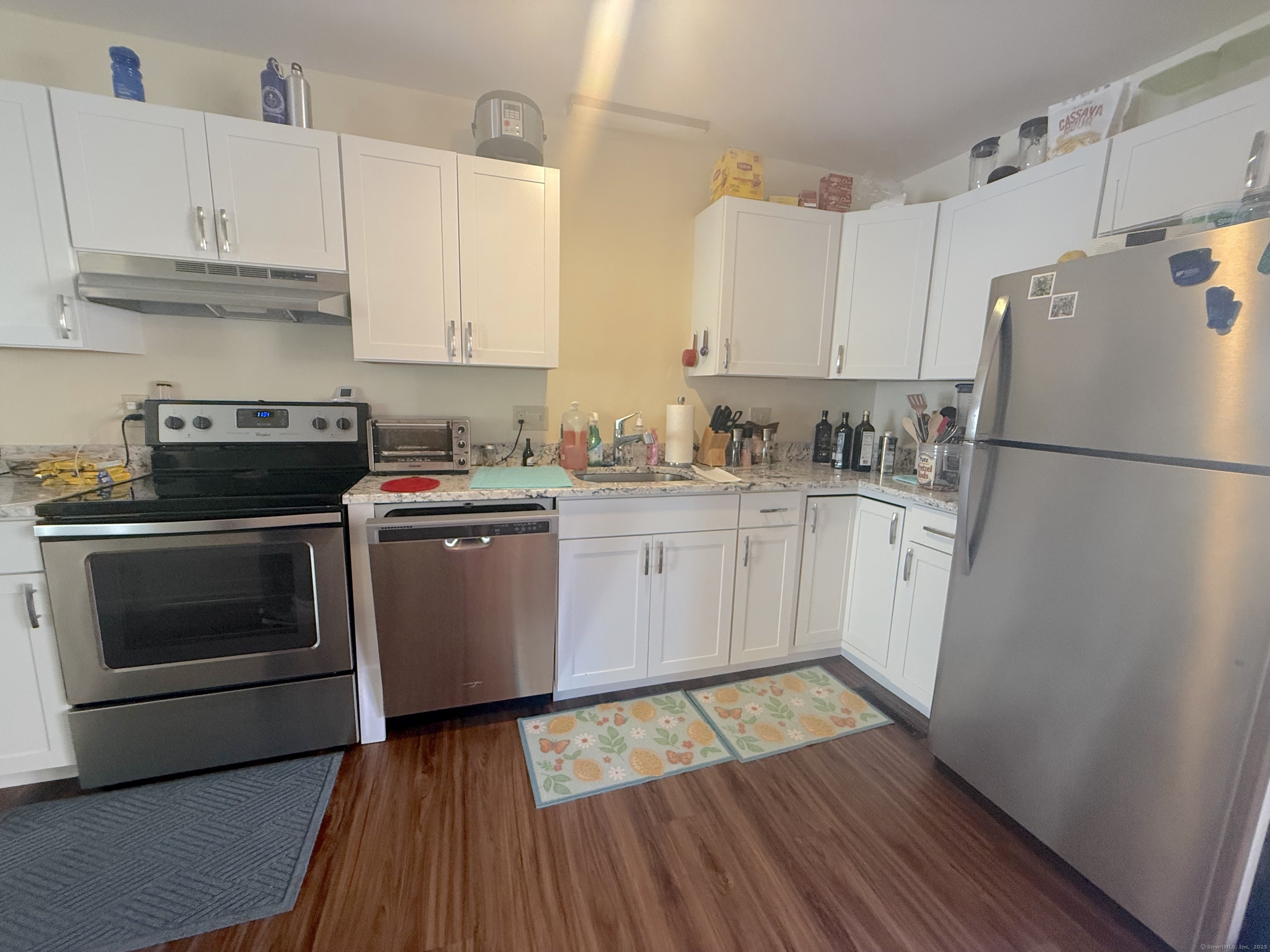87 Gerrish Avenue, Unit T2 East Haven, CT 06512 - Photo 4 of 12 a kitchen with a white stove top oven and refrigerator