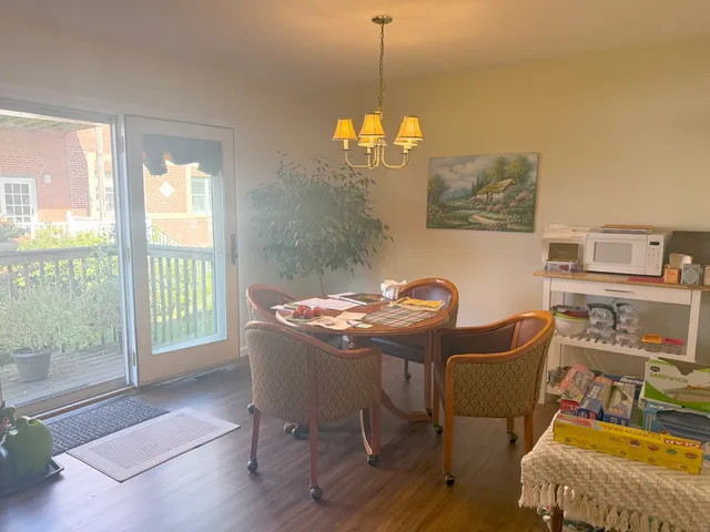 a dining room with furniture and window