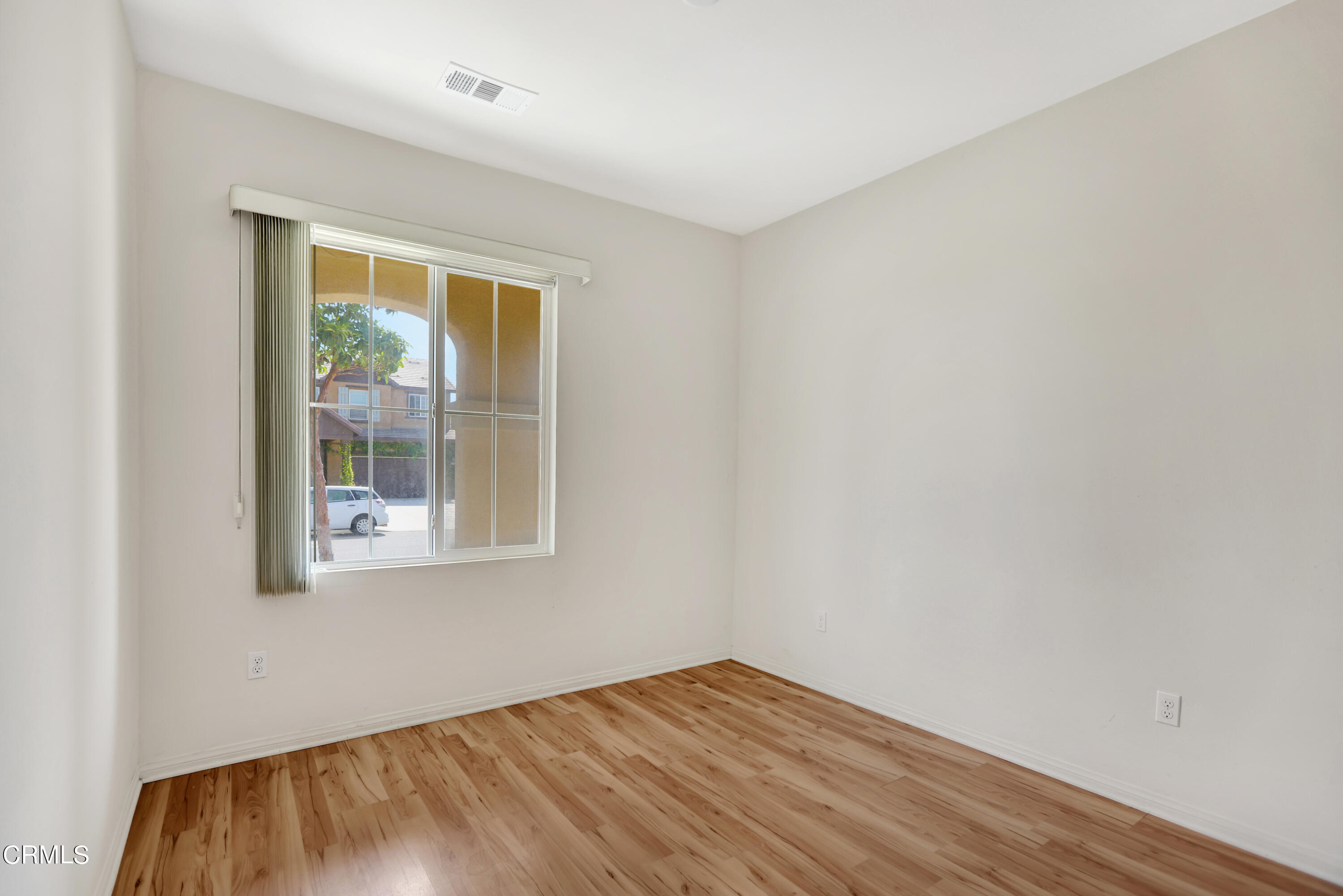 511 Whalen Way Oxnard, CA 93036 - Photo 17 of 28 a view of an empty room with wooden floor and a window