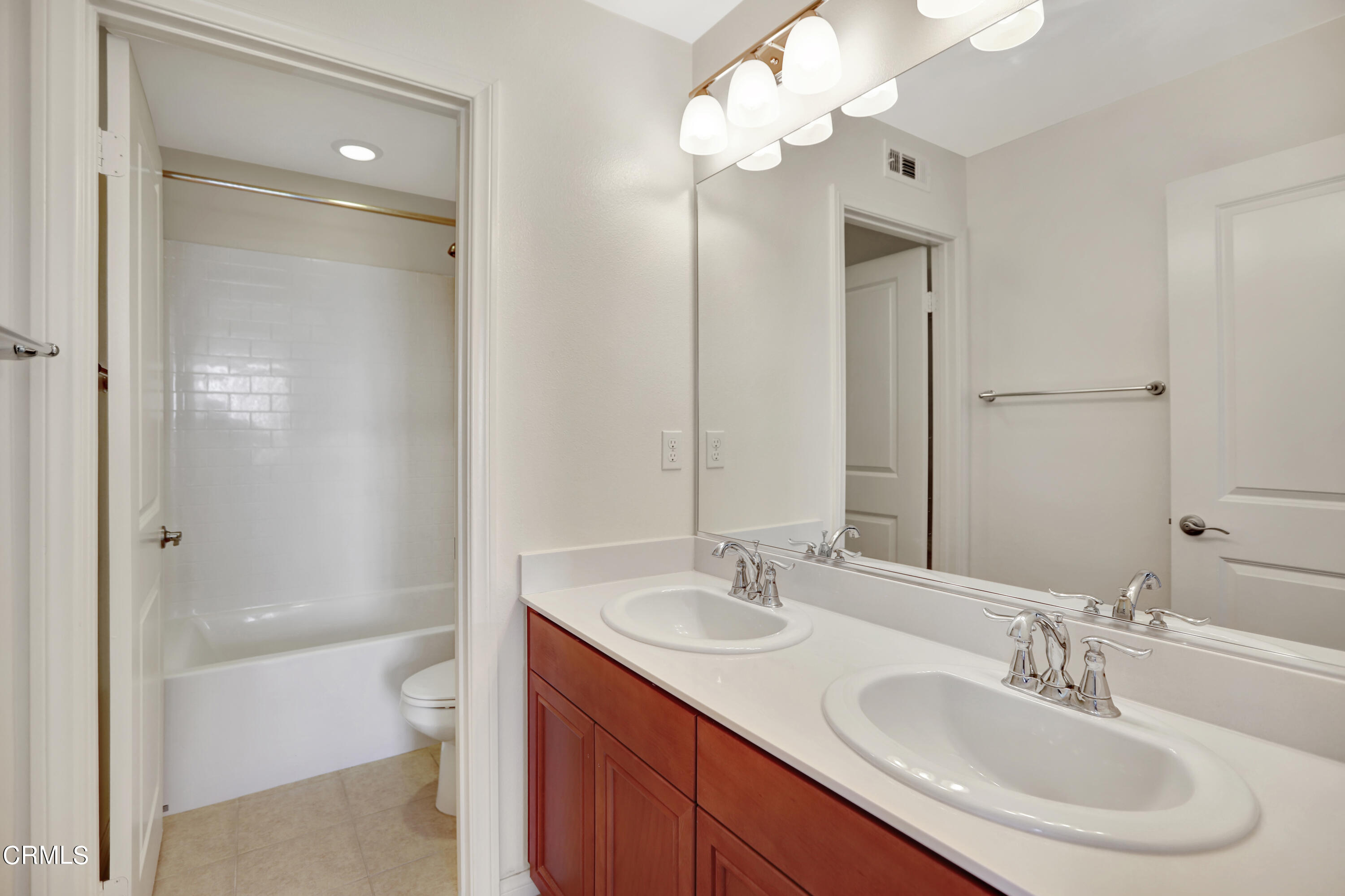 511 Whalen Way Oxnard, CA 93036 - Photo 22 of 28 a bathroom with a sink a toilet and a mirror