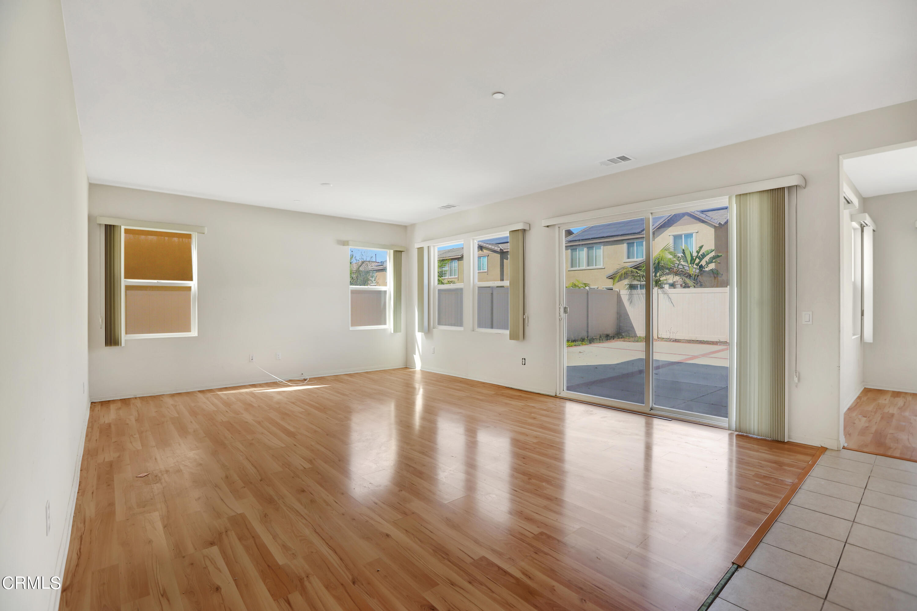 511 Whalen Way Oxnard, CA 93036 - Photo 6 of 28 a view of an empty room with wooden floor and a window