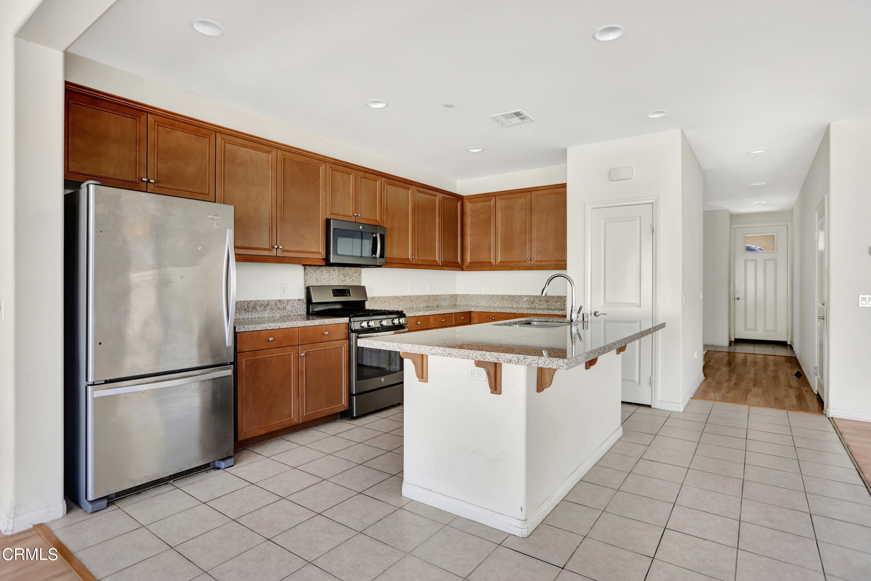 511 Whalen Way Oxnard, CA 93036 - Photo 9 of 28 a kitchen with stainless steel appliances granite countertop a refrigerator stove top oven and sink
