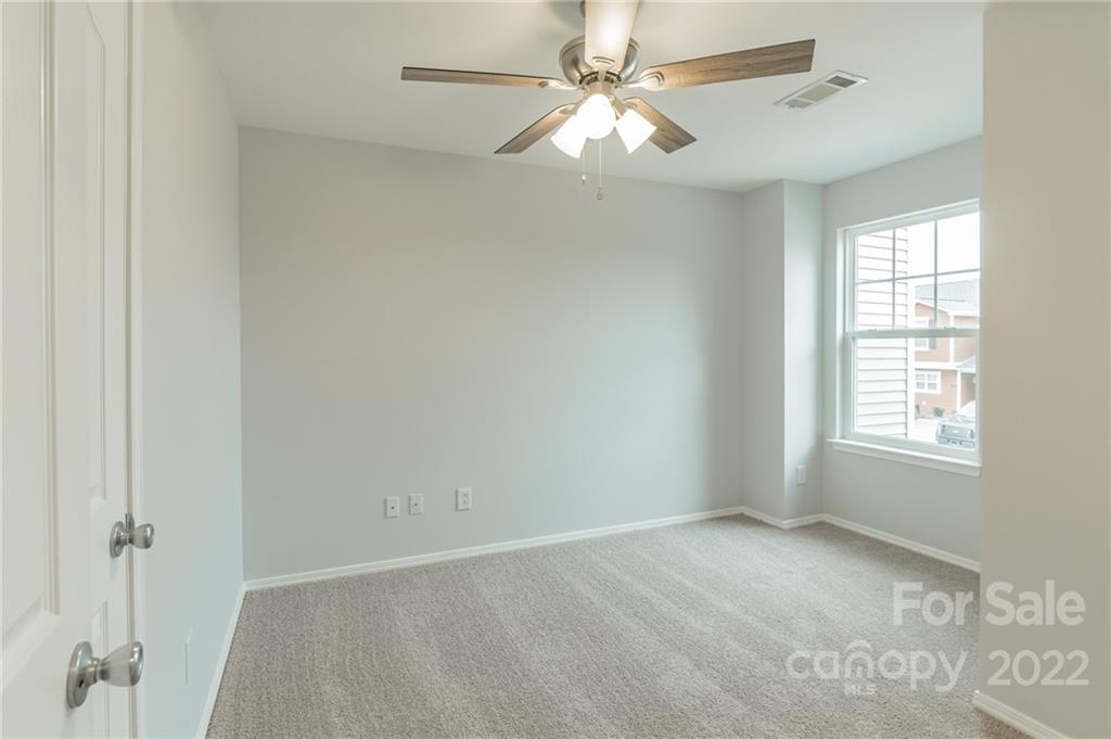 433 Hunters Dance Road Fort Mill, SC 29708 - Photo 12 of 25 an empty room with windows and fan