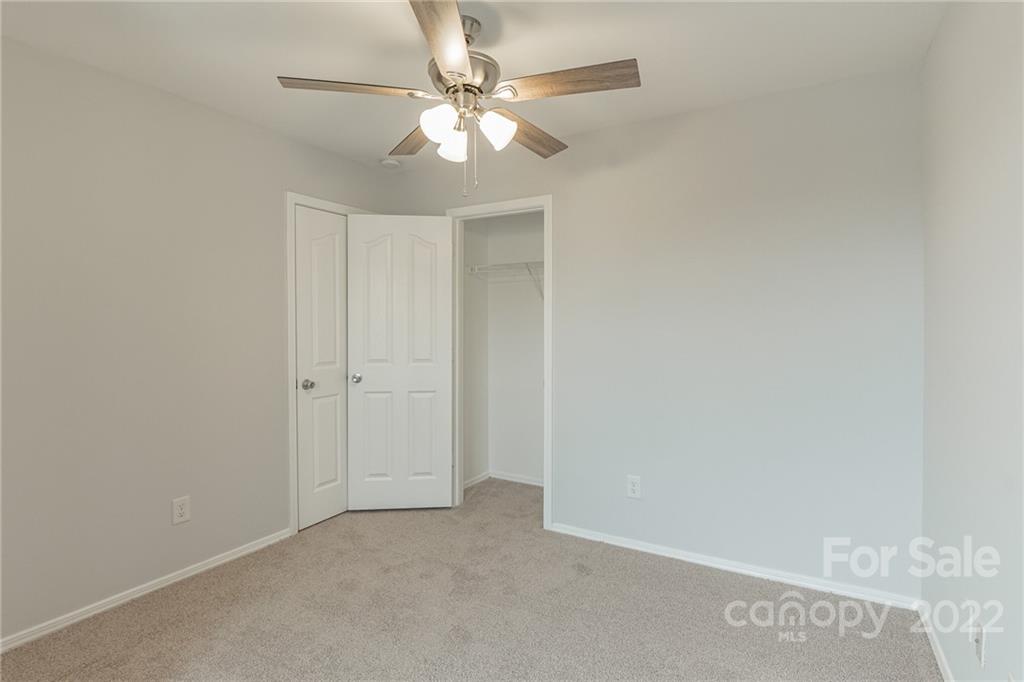 433 Hunters Dance Road Fort Mill, SC 29708 - Photo 13 of 25 an empty room with a ceiling fan and a window