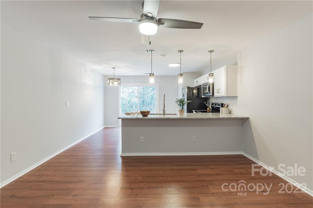 433 Hunters Dance Road Fort Mill, SC 29708 - Photo 3 of 25 a view of kitchen and hall with wooden floor
