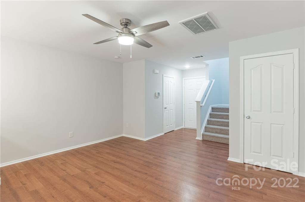433 Hunters Dance Road Fort Mill, SC 29708 - Photo 4 of 25 an empty room with wooden floor and staircase
