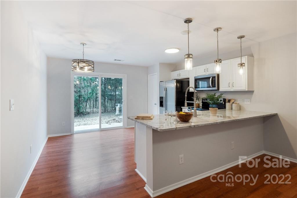 433 Hunters Dance Road Fort Mill, SC 29708 - Photo 5 of 25 a view of kitchen and living room with wooden floor