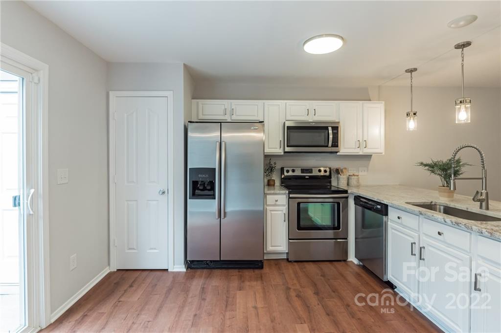 433 Hunters Dance Road Fort Mill, SC 29708 - Photo 6 of 25 a kitchen with granite countertop a refrigerator and a stove top oven