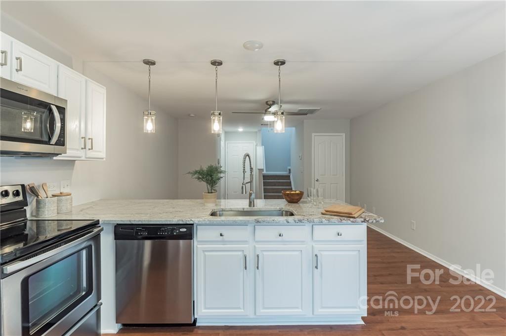 433 Hunters Dance Road Fort Mill, SC 29708 - Photo 8 of 25 a kitchen with stainless steel appliances granite countertop a sink a stove and a microwave