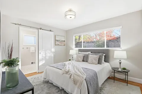 a bedroom with a bed and a couch