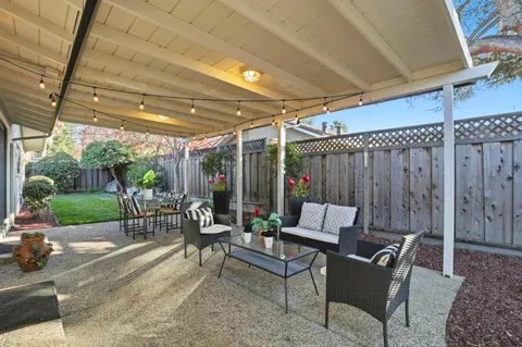 a outdoor dining space with furniture and garden view