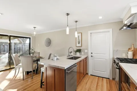 a kitchen with a sink appliances and cabinets