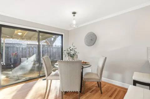 a view of a dining room with furniture wooden floor and a chandelier