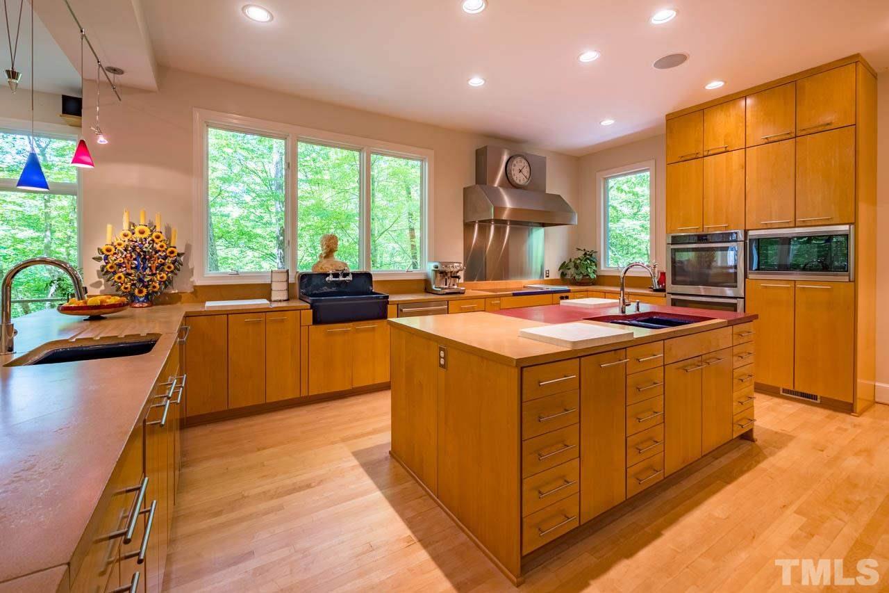 5415 Taproot Lane Durham, NC 27705 - Photo 11 of 30 a dining hall with stainless steel appliances granite countertop a sink counter space and a large window