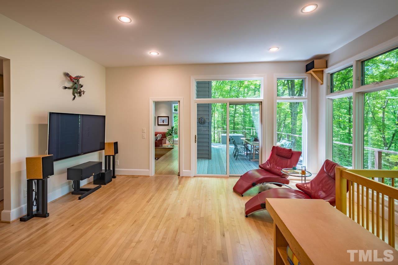 5415 Taproot Lane Durham, NC 27705 - Photo 14 of 30 a living room with furniture a flat screen tv and large windows